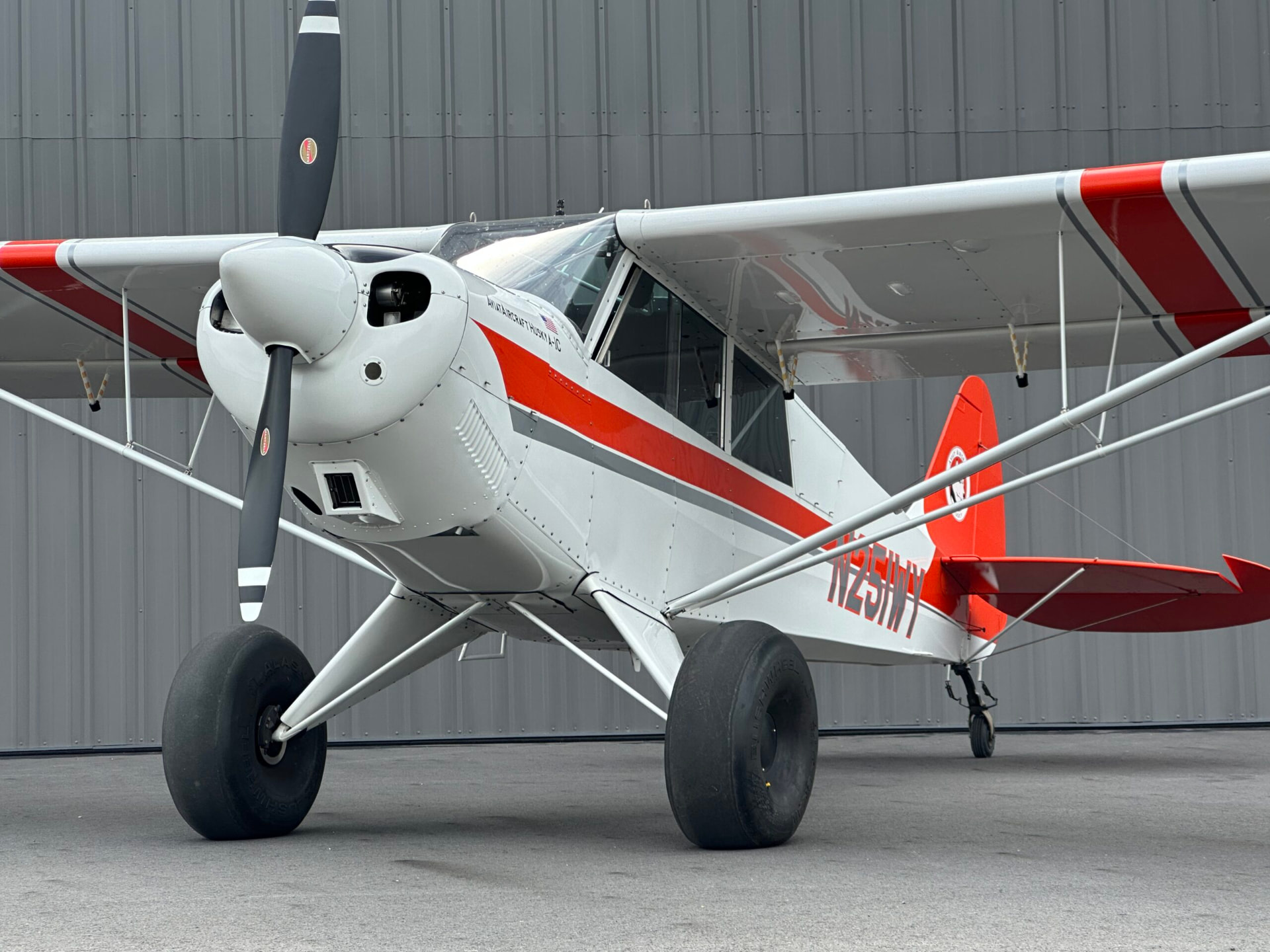 Aviat Husky A-1C on the ramp outside a hangar